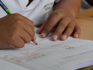a child writes in a notebook